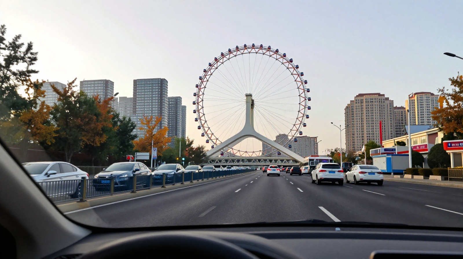 Car driver view of Tianjin Eye Ferris Wheel and modern highway traffic during the drive from downtown Tianjin to Binhai New Area