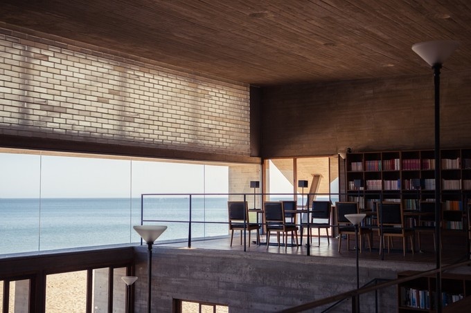 Inside the minimalist Lonely Library with views of the ocean at Aranya