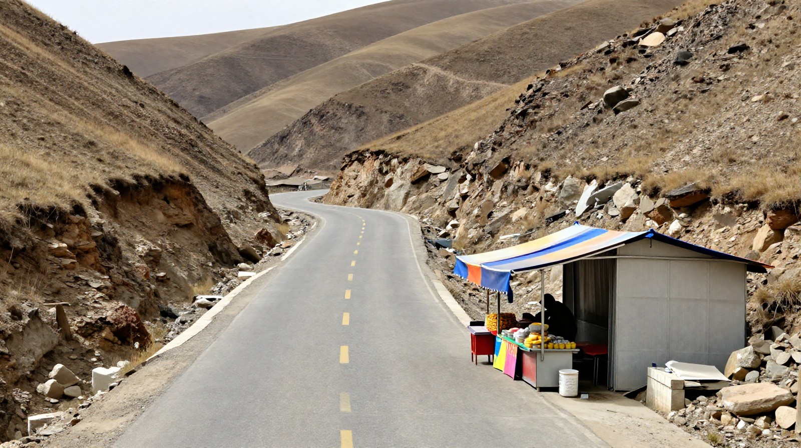 A winding rural road in Shanxi province with a traditional roadside food stall under the open sky.