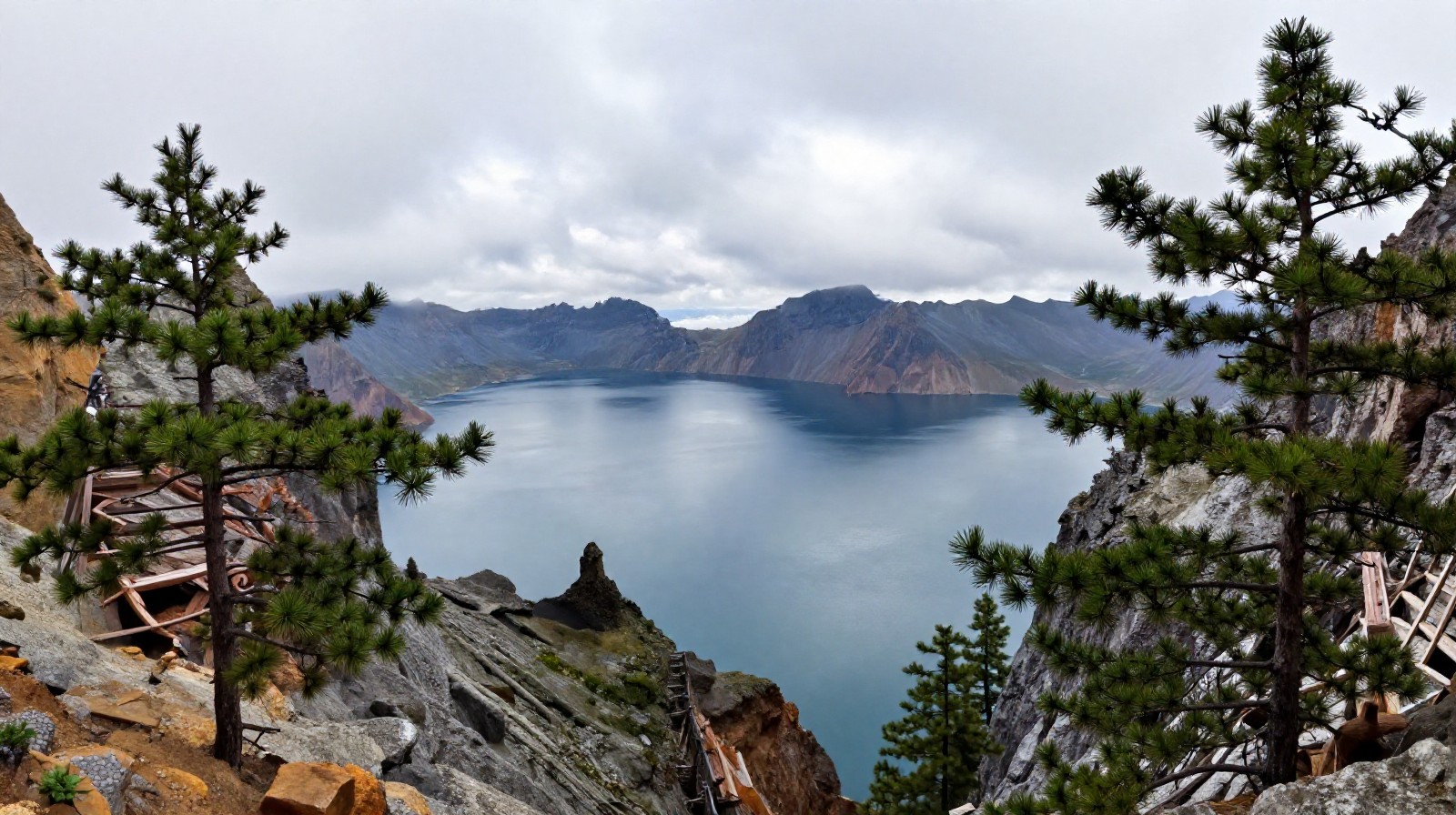 Changbaishan Tianchi (Heaven Lake) surrounded by mountain peaks and mist, showing the geological beauty of Jilin
