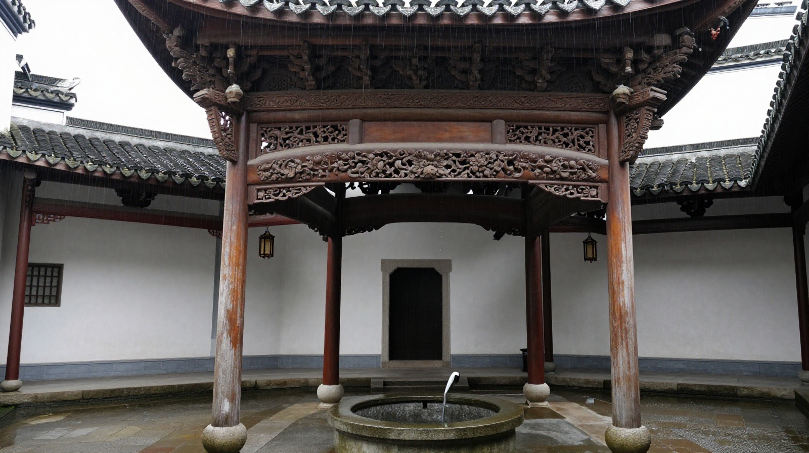 Interior view of a traditional Huizhou Si Shui Gui Tang courtyard with rain falling into a central well and detailed wood carvings on the roof eaves