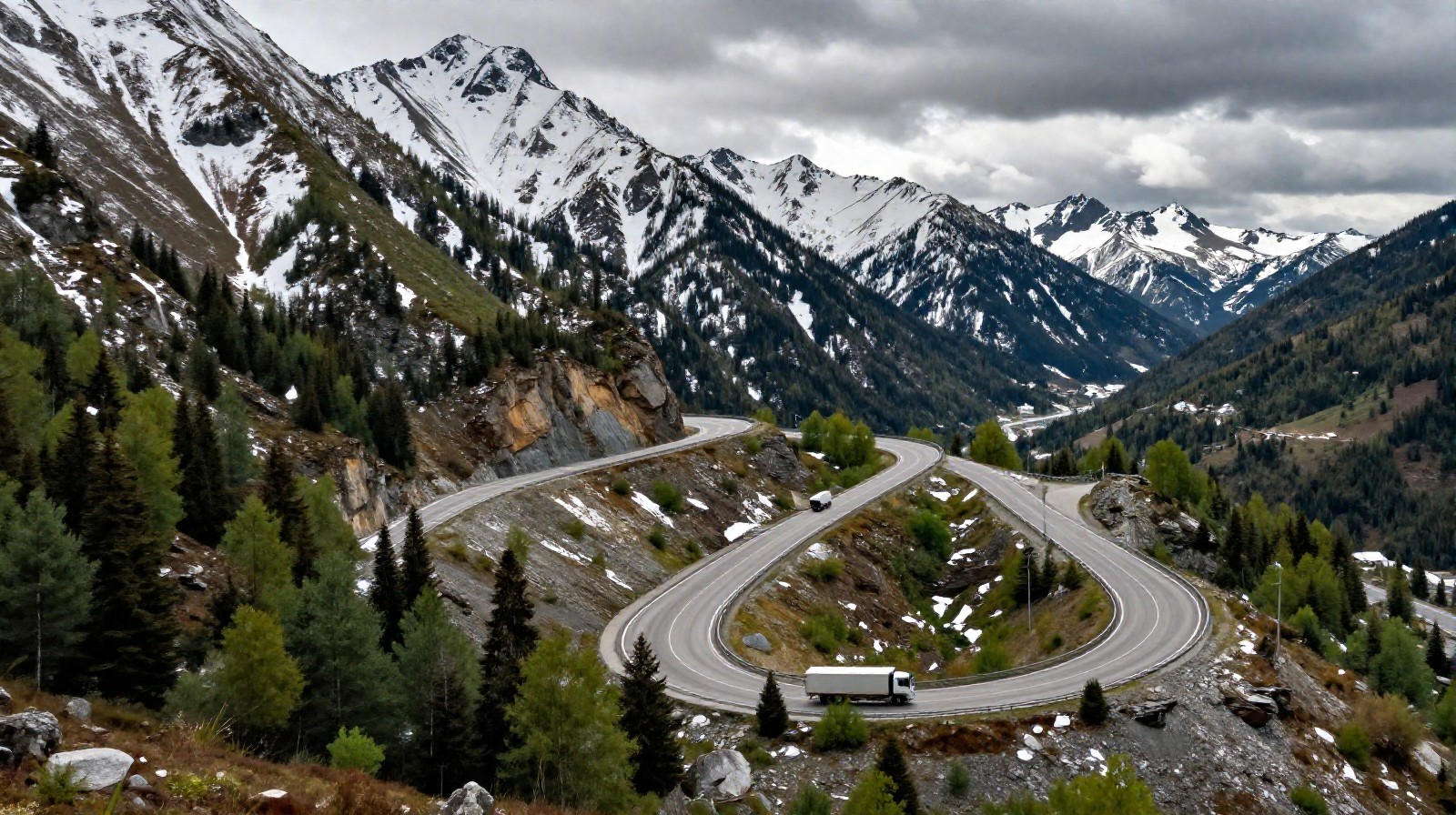 Winding asphalt road through the transition zone between snow-covered peaks and green forests in Yunnan