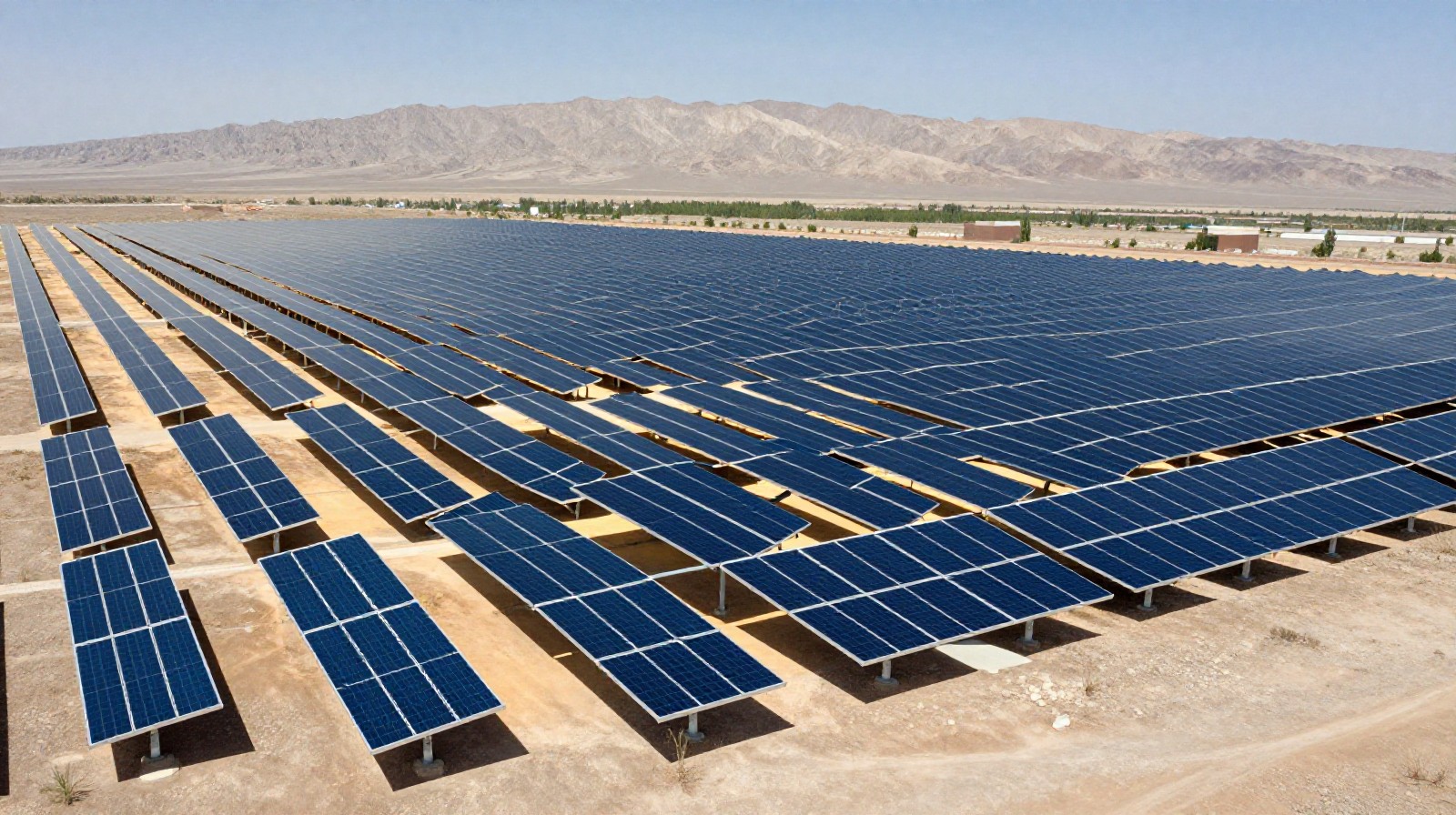 Rows of solar panels installed in the Qaidam Basin desert landscape for renewable energy generation