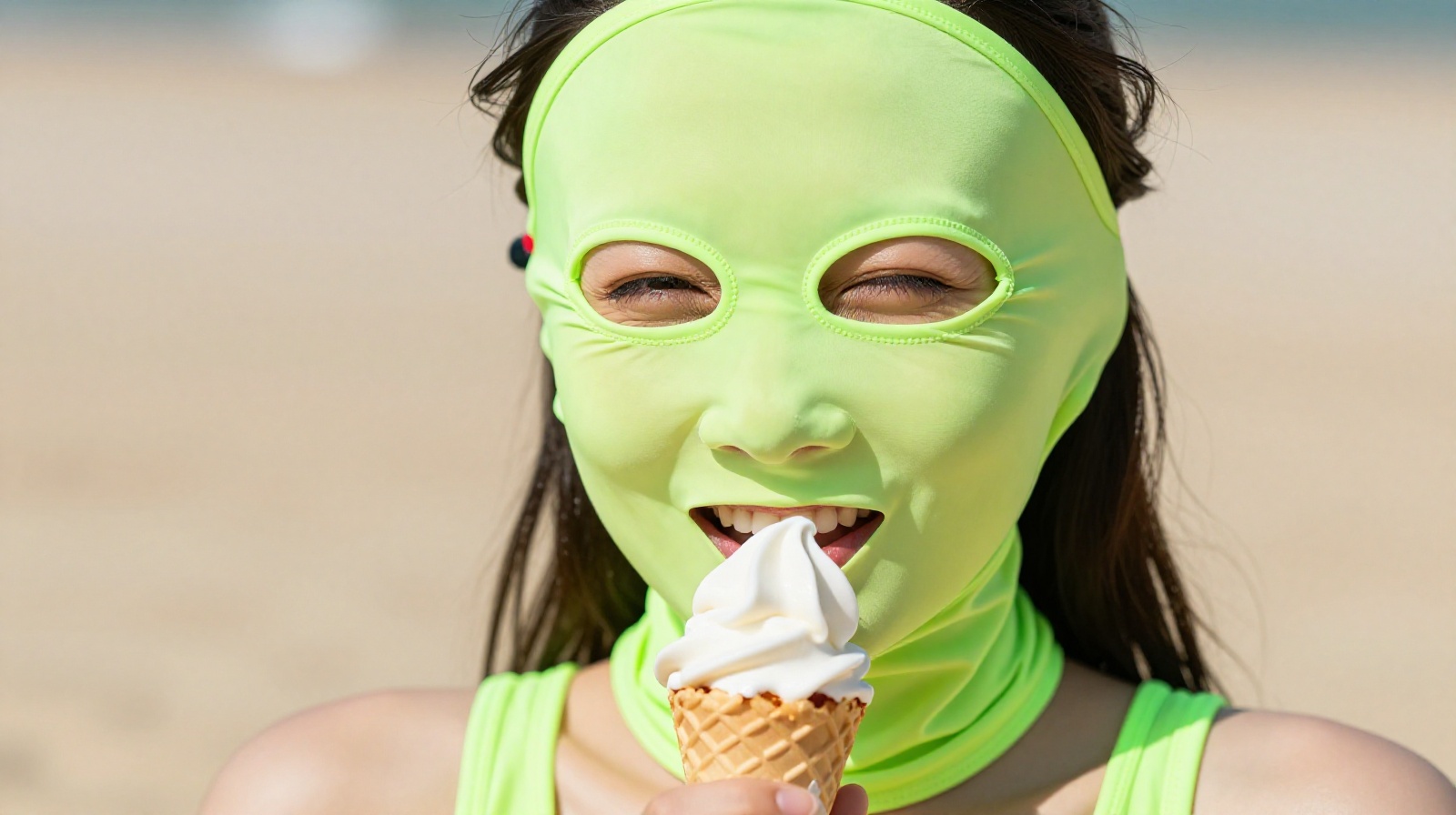 Woman wearing a bright neon green facekini mask covering her whole face while relaxing on a sunny beach in China