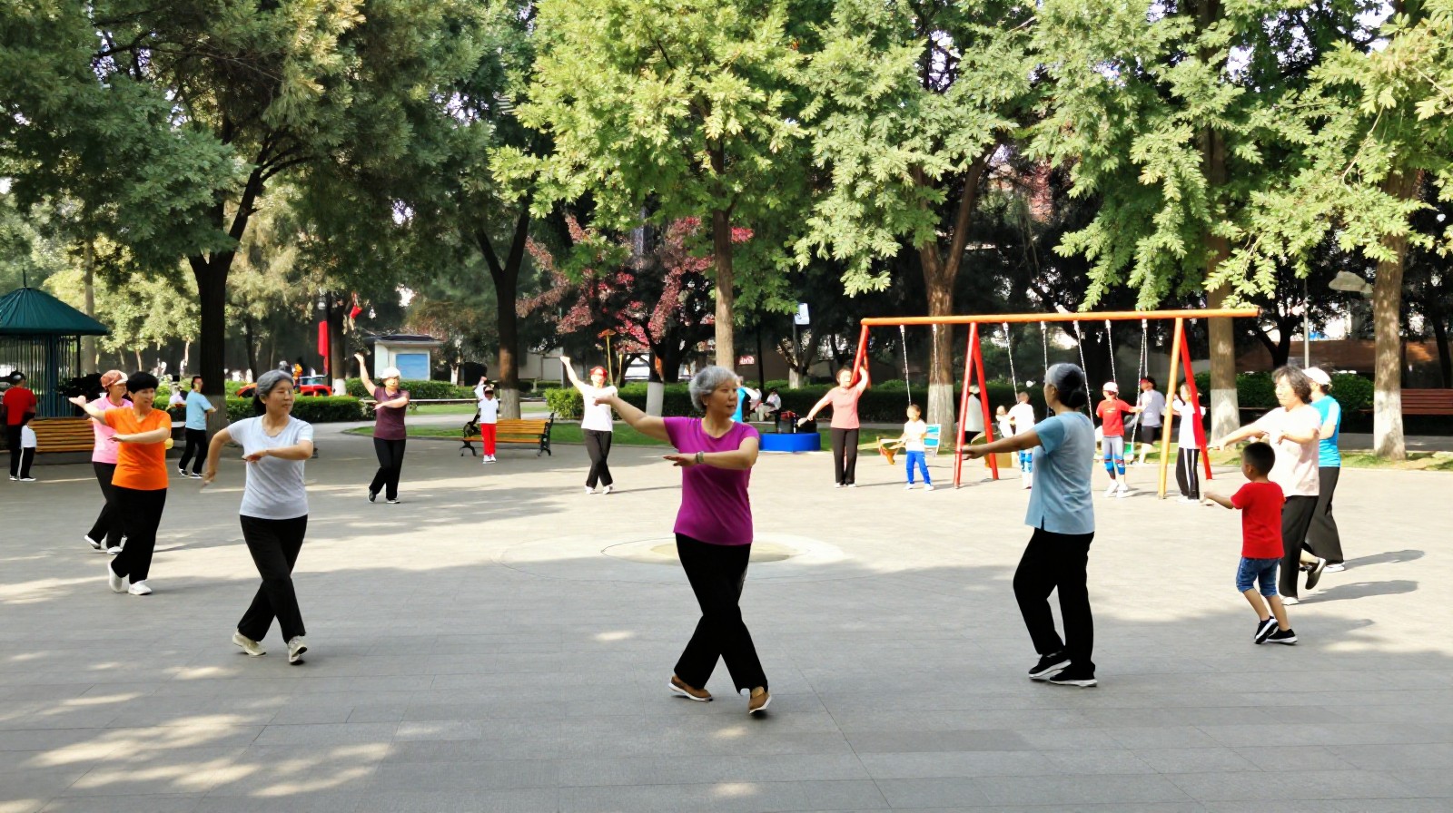 People enjoying free time in a Chinese urban park, with seniors exercising and families relaxing.