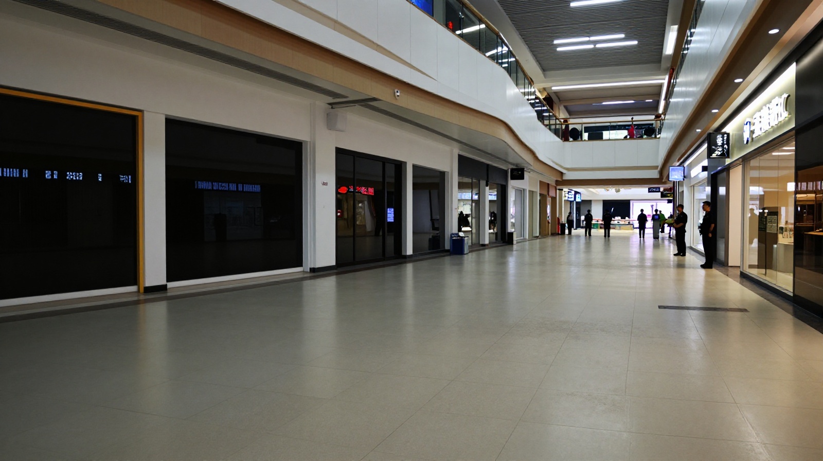 Empty corridor in a Chinese shopping mall during the ghost mall era, showing closed stores and minimal foot traffic