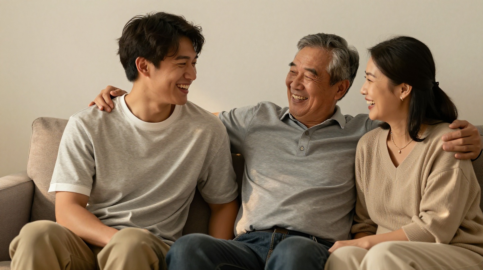 An adult child sharing a laugh with her aging parents in a cozy living room
