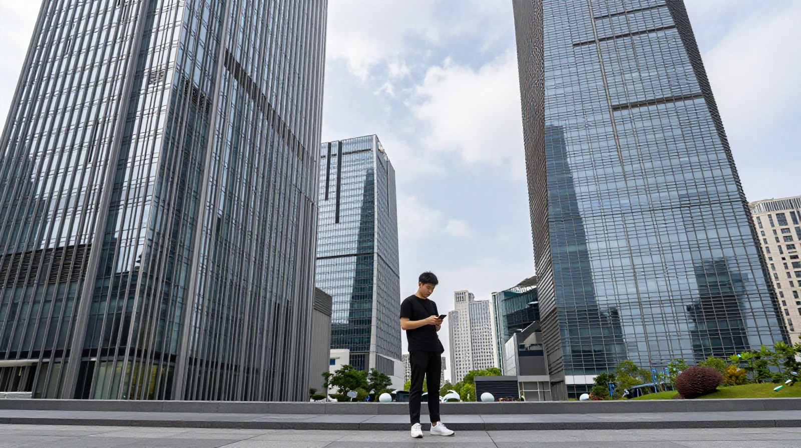 A young Chinese professional standing outside modern skyscrapers in Shanghai, symbolizing the pressure of the urban job market