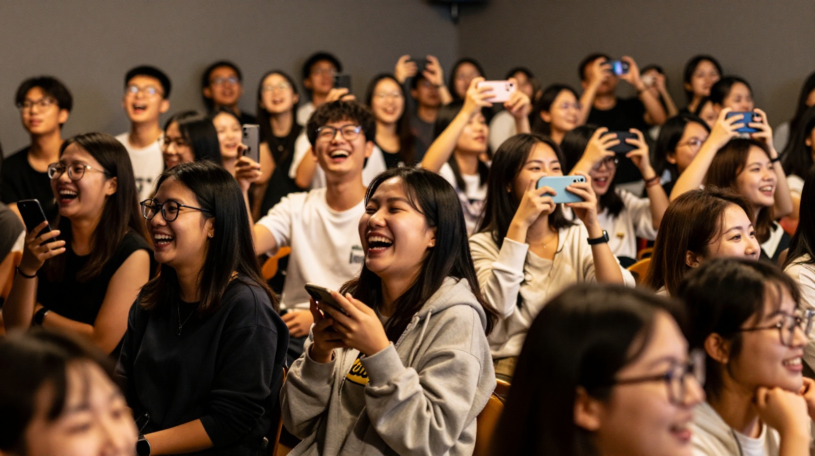 Diverse audience enjoying a stand-up show in China, laughing and sharing a moment of joy