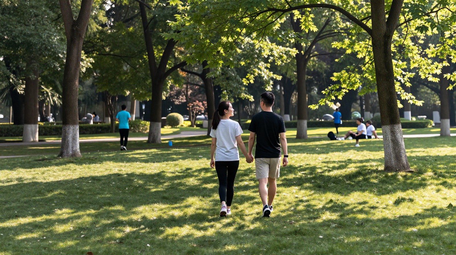 Couple walking hand in hand in a public park in Chengdu