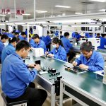 Workers assembling smart plant pots on a flexible assembly line in a Shenzhen manufacturing facility