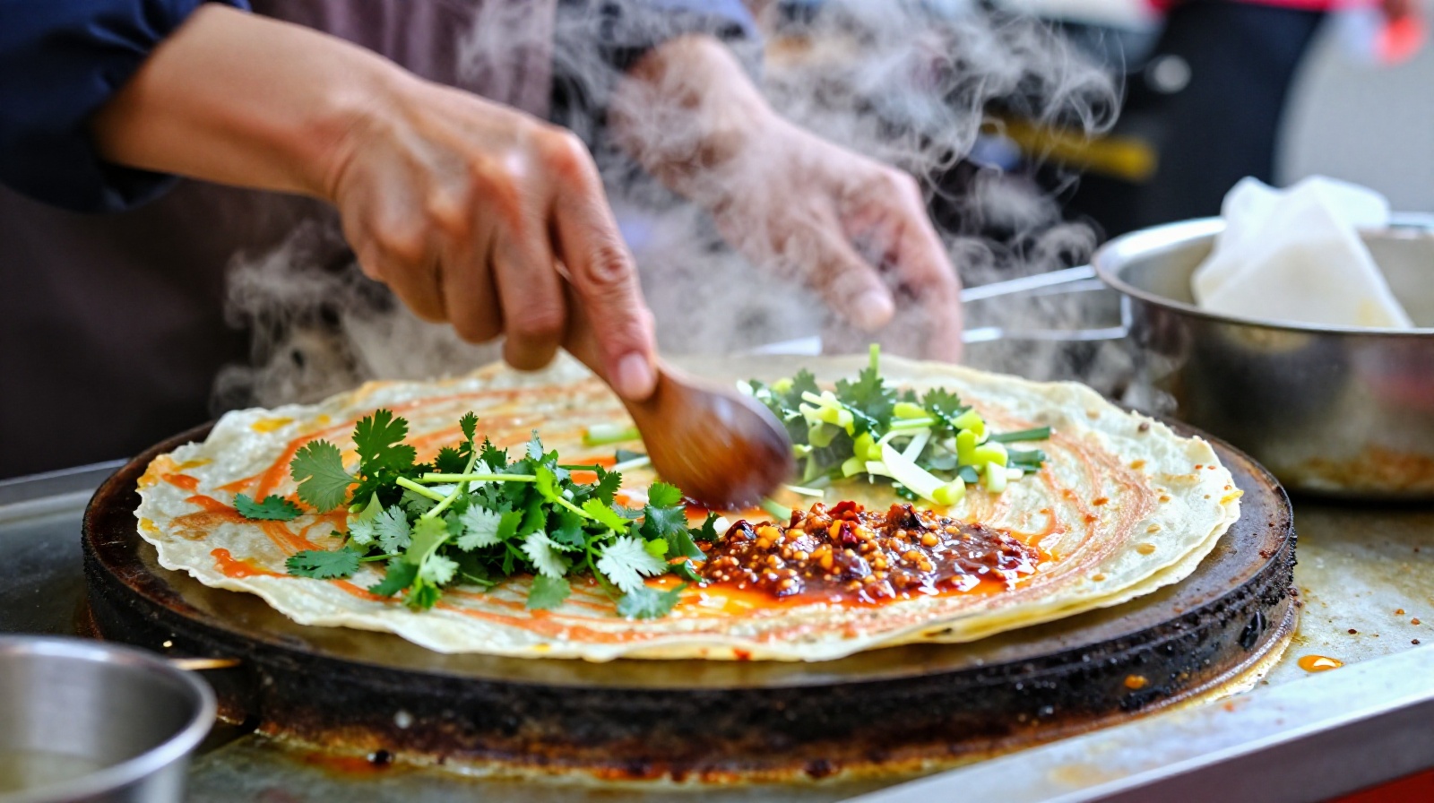 A Chinese street food vendor preparing a savory jianbing crepe for customers early in the morning with visible steam rising from the cooking station