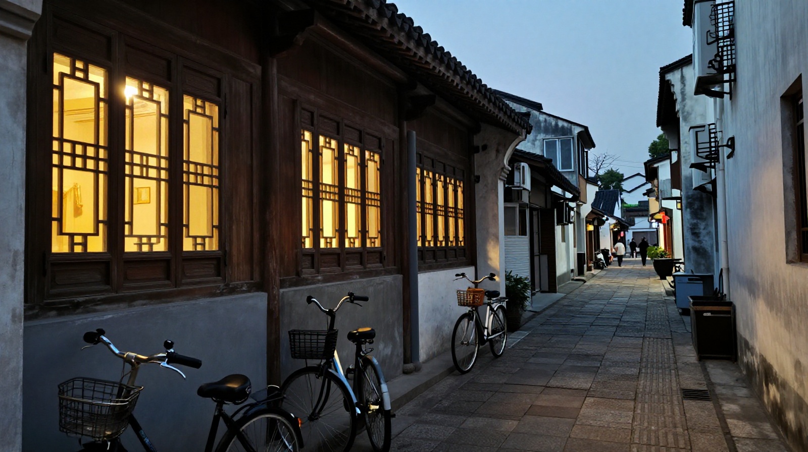 Residential windows lit up at night in an old Chinese water town district showing families living alongside tourist attractions.