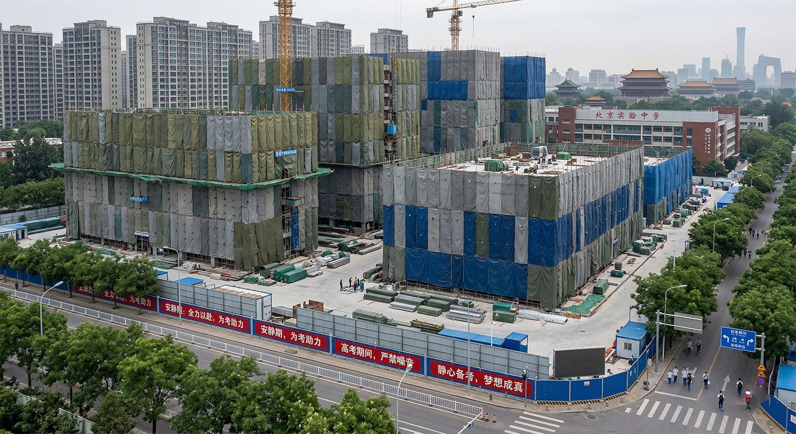 Construction sites in a Chinese city covered with sound-dampening tarps during the Gaokao examination period.