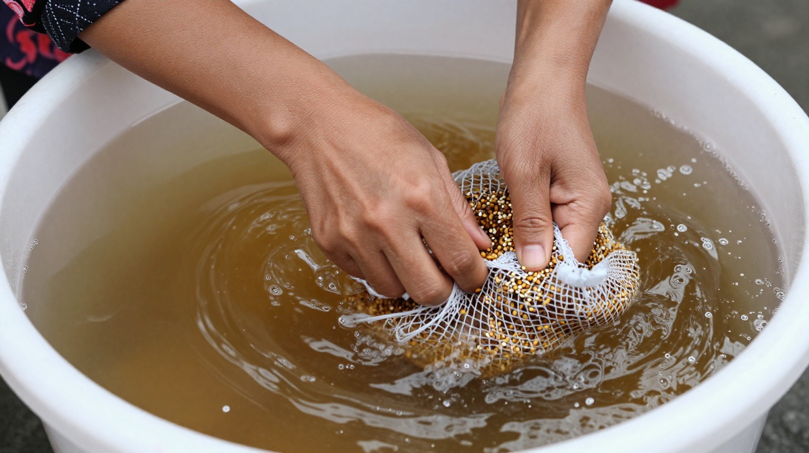 Street vendor making traditional Bingfen by hand rubbing seed bags in water