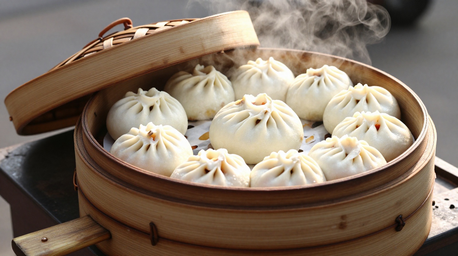 Close-up of traditional bamboo steamers filled with various types of Chinese baozi