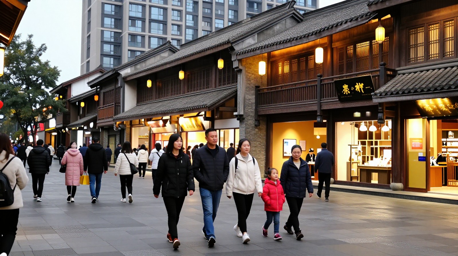 A family strolling along Chunxi Road shopping district in Chengdu at dusk.