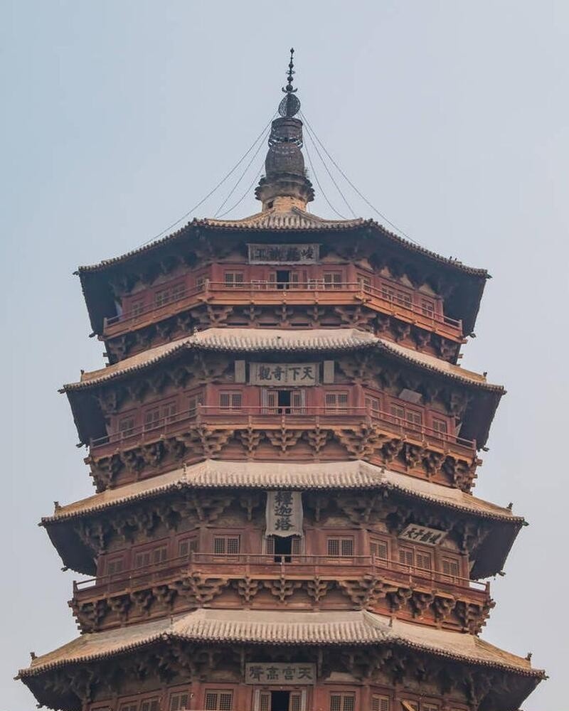 Close-up view of the intricate interlocking wooden brackets and joinery at the base of the Yingxian Wooden Pagoda, demonstrating traditional Chinese construction without nails