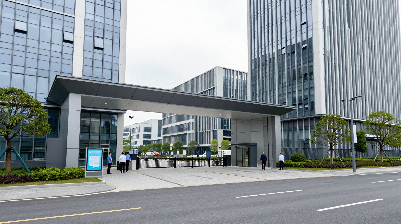 Entrance to a modern high-tech industrial zone in Dongguan with glass buildings and professionals walking outside