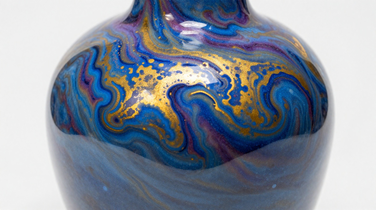 A close-up photo of a Chinese Yao Bian ceramic vase displaying swirling cosmic patterns in blue and gold glazes