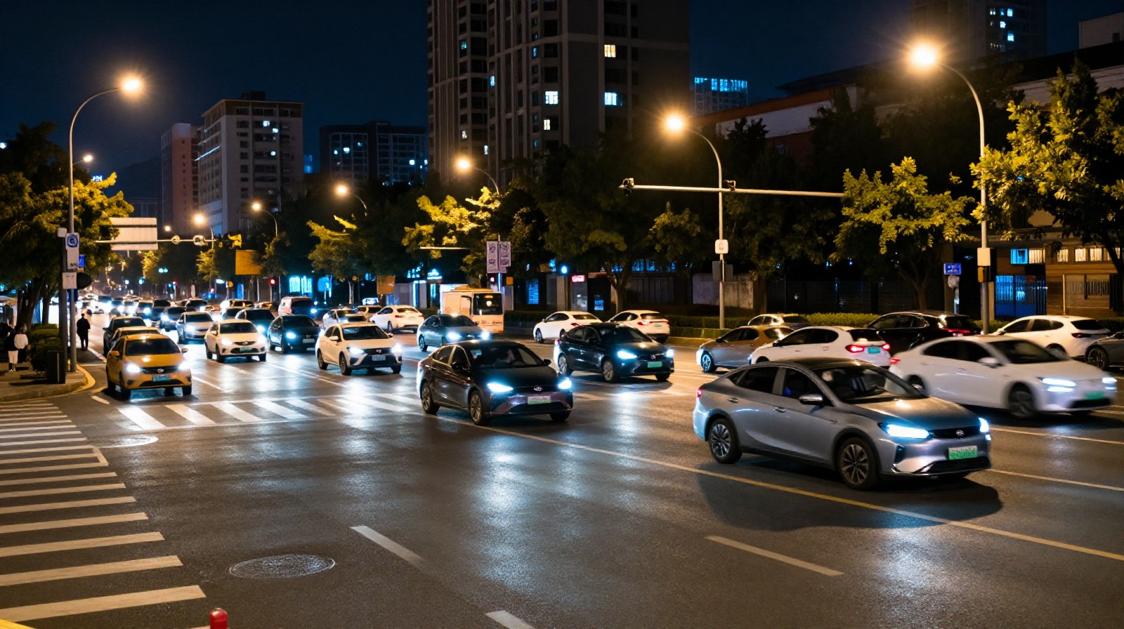 Nighttime traffic scene in a Chinese metropolis showing the flow of electric vehicles and urban infrastructure.