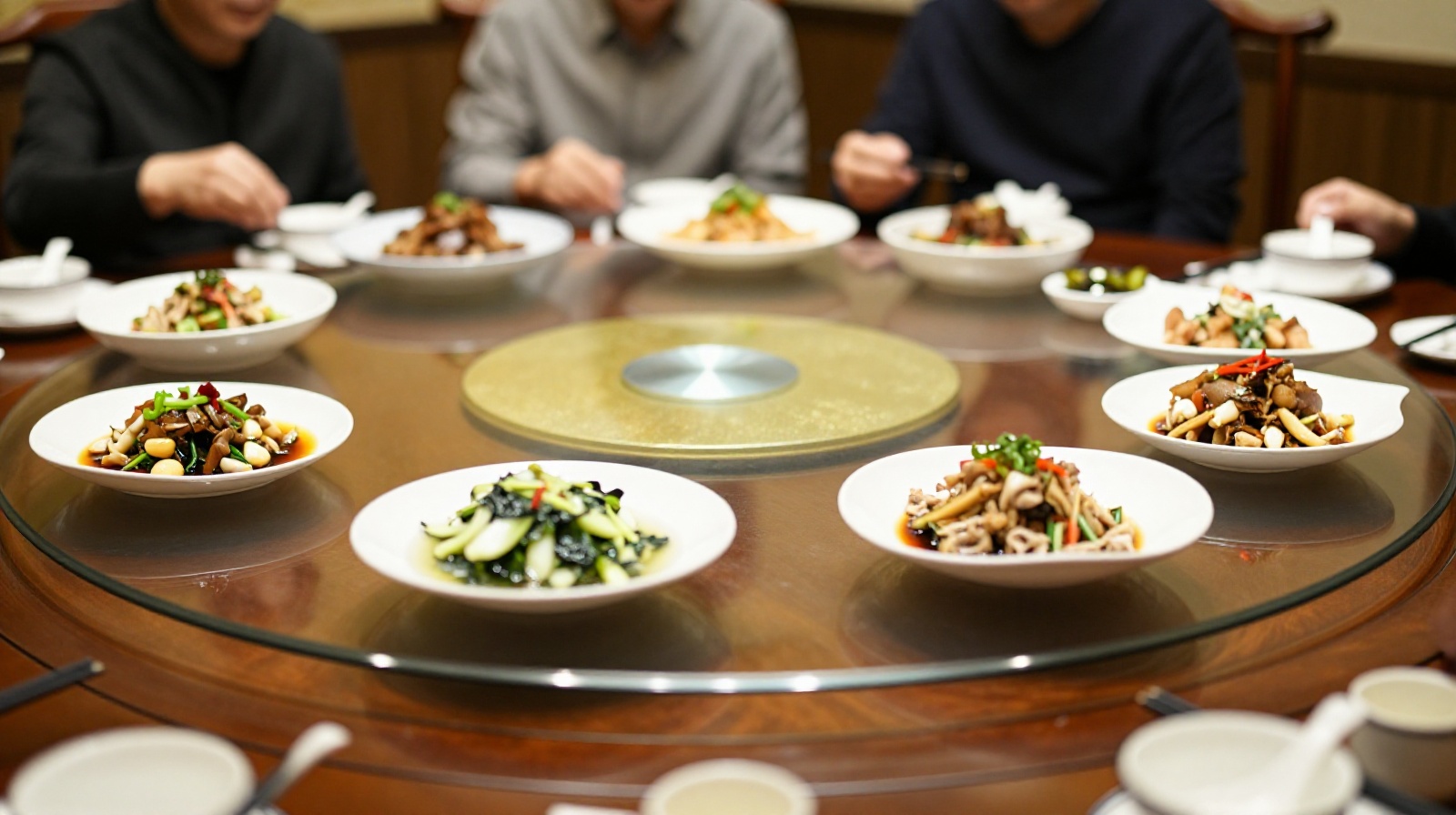 A view of a traditional Chinese business dinner table setup with communal dishes and seating arrangements indicating hierarchy.
