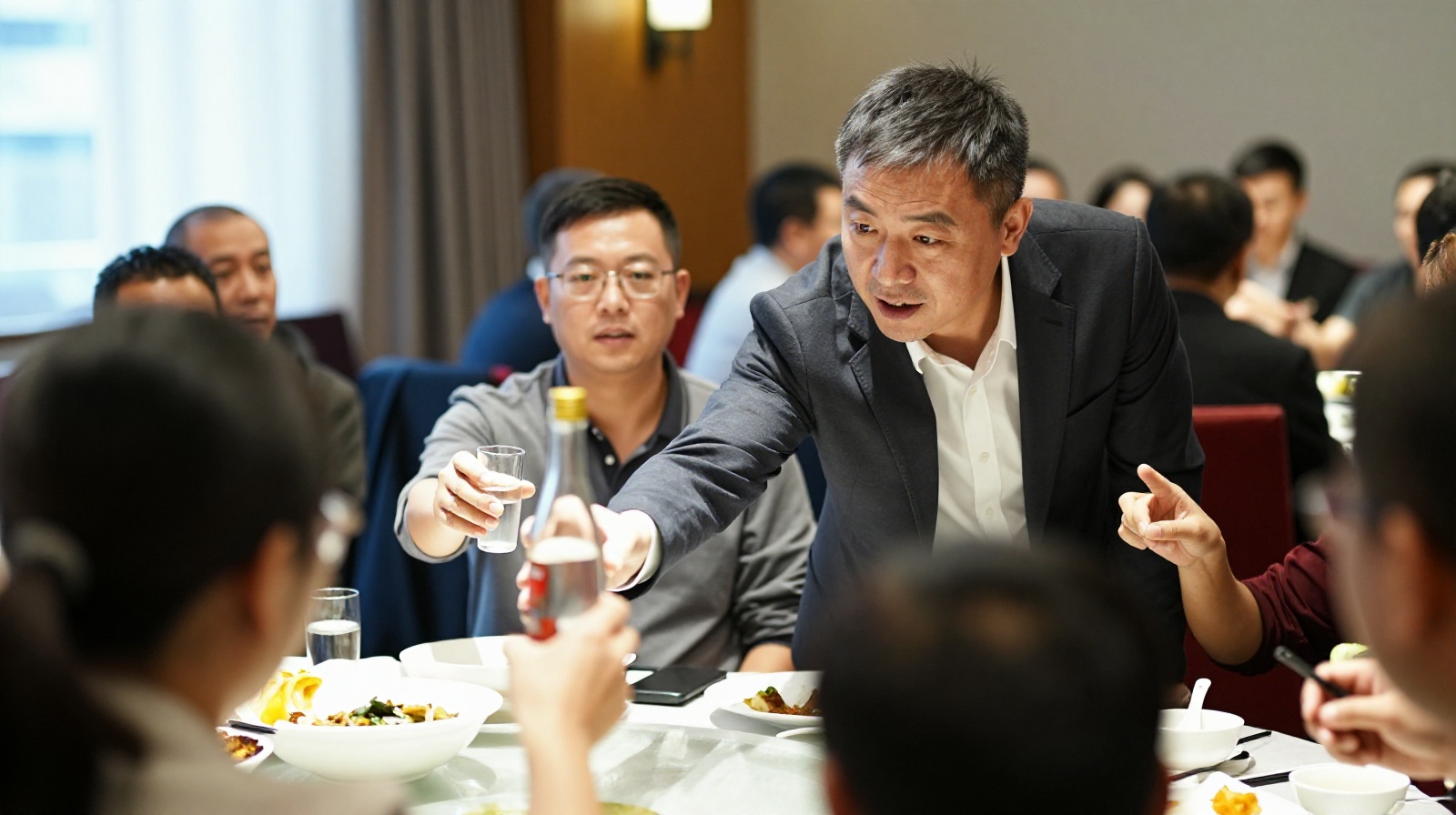 Business partners engaging in a toast during a Chinese dinner, highlighting the intensity and focus of 'Ganbei' culture.