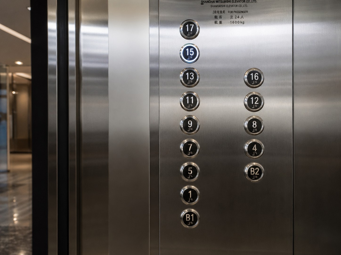 Close up of elevator buttons in a Chinese skyscraper showing missing floor 14 due to phonetic association with death