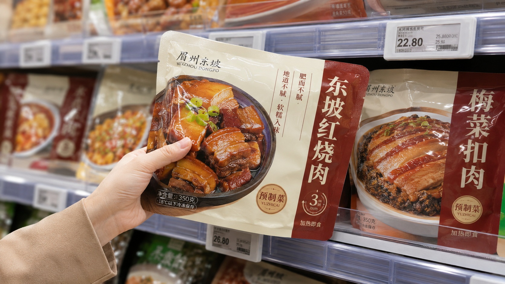 Close-up view of vacuum-sealed pre-made meals (yuzhicai) on a supermarket shelf in China, highlighting the packaging and variety available for home consumption.
