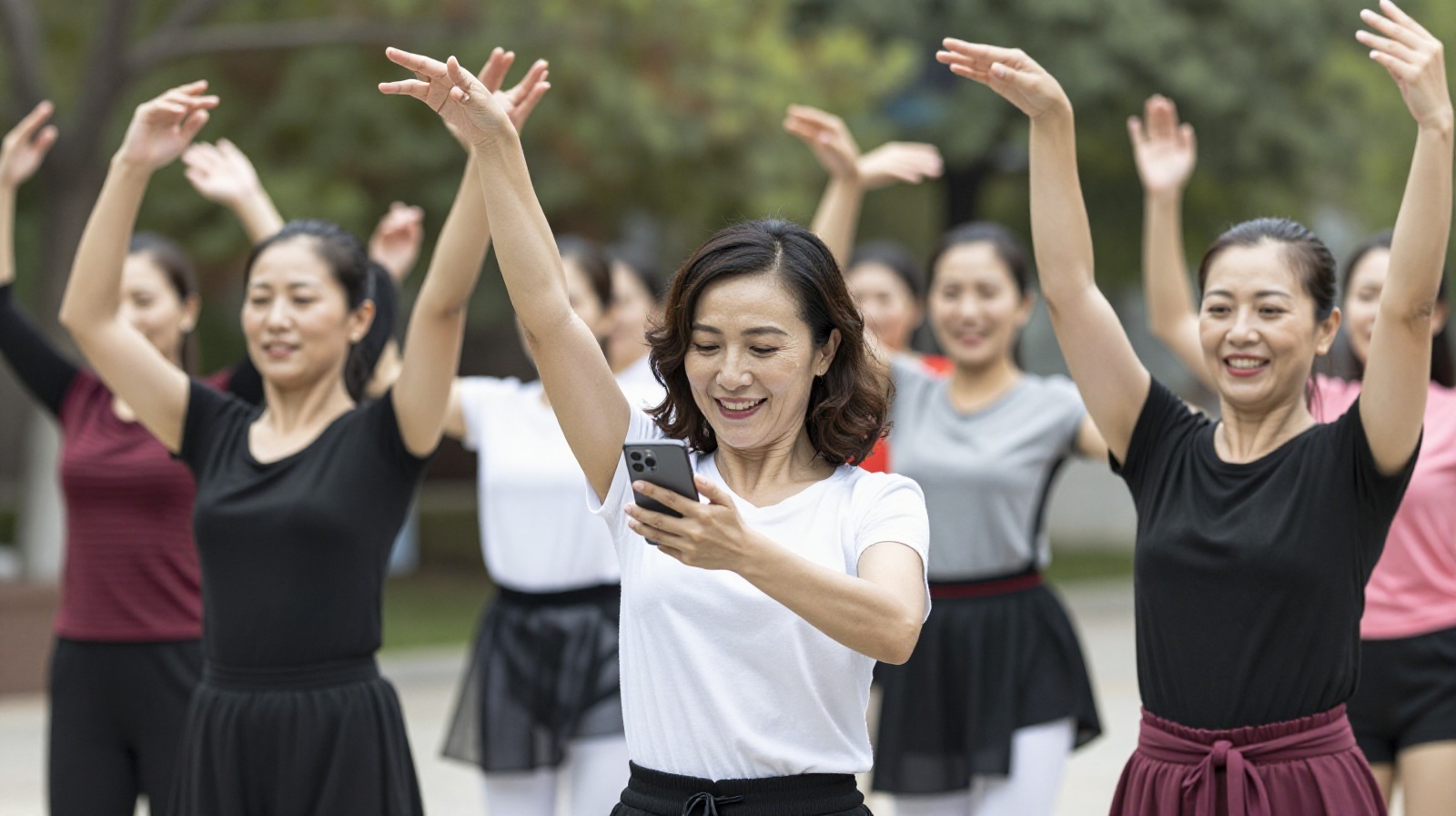 Chinese women enjoying square dancing outdoors, blending traditional movement with modern technology.