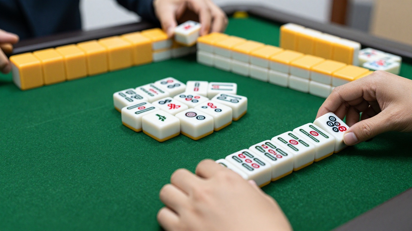 Close-up view of mahjong tile combinations showing sequences and triplets