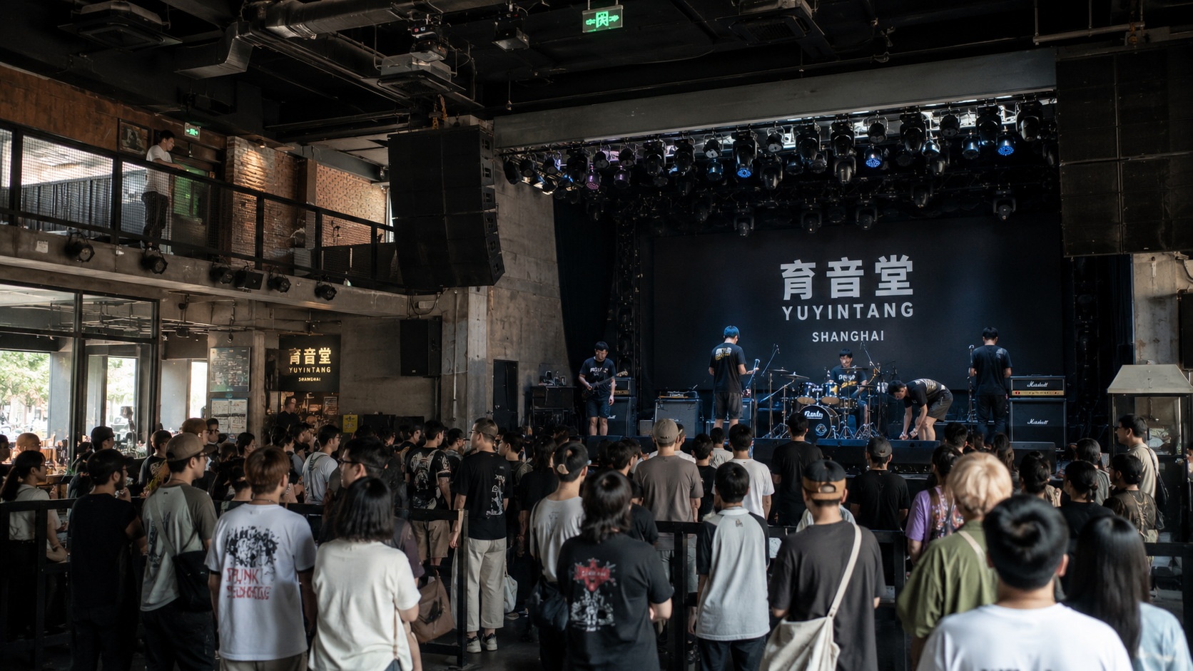Interior view of a popular livehouse venue in Shanghai showing the audience and stage setup during an indie music event.