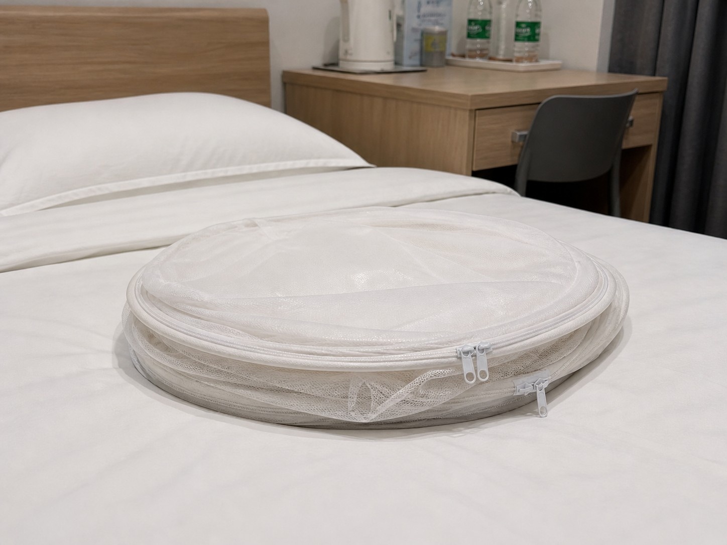 Folded Mongolian tent style mosquito net ready for use in a Chinese bedroom