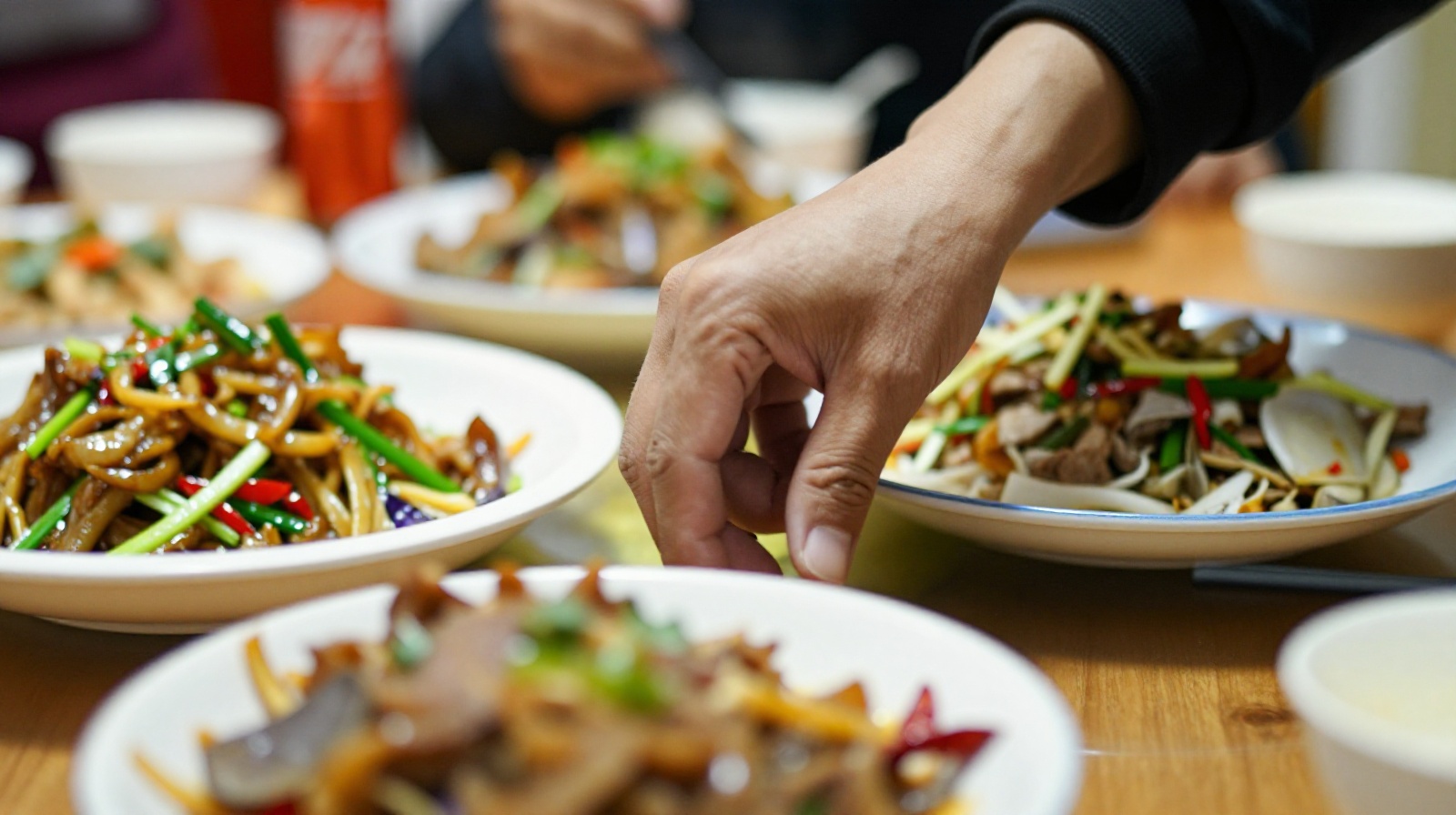 Close up of shared dishes on a Chinese restaurant table representing communal dining culture