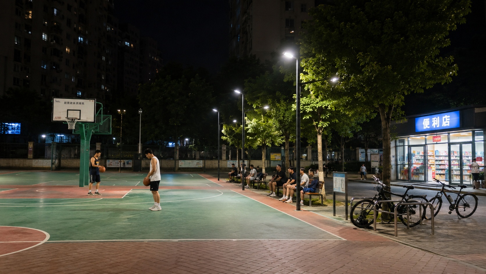 An empty but well-lit public basketball court in a Chinese city at night, showing how municipal investment supports safe recreational spaces for residents.