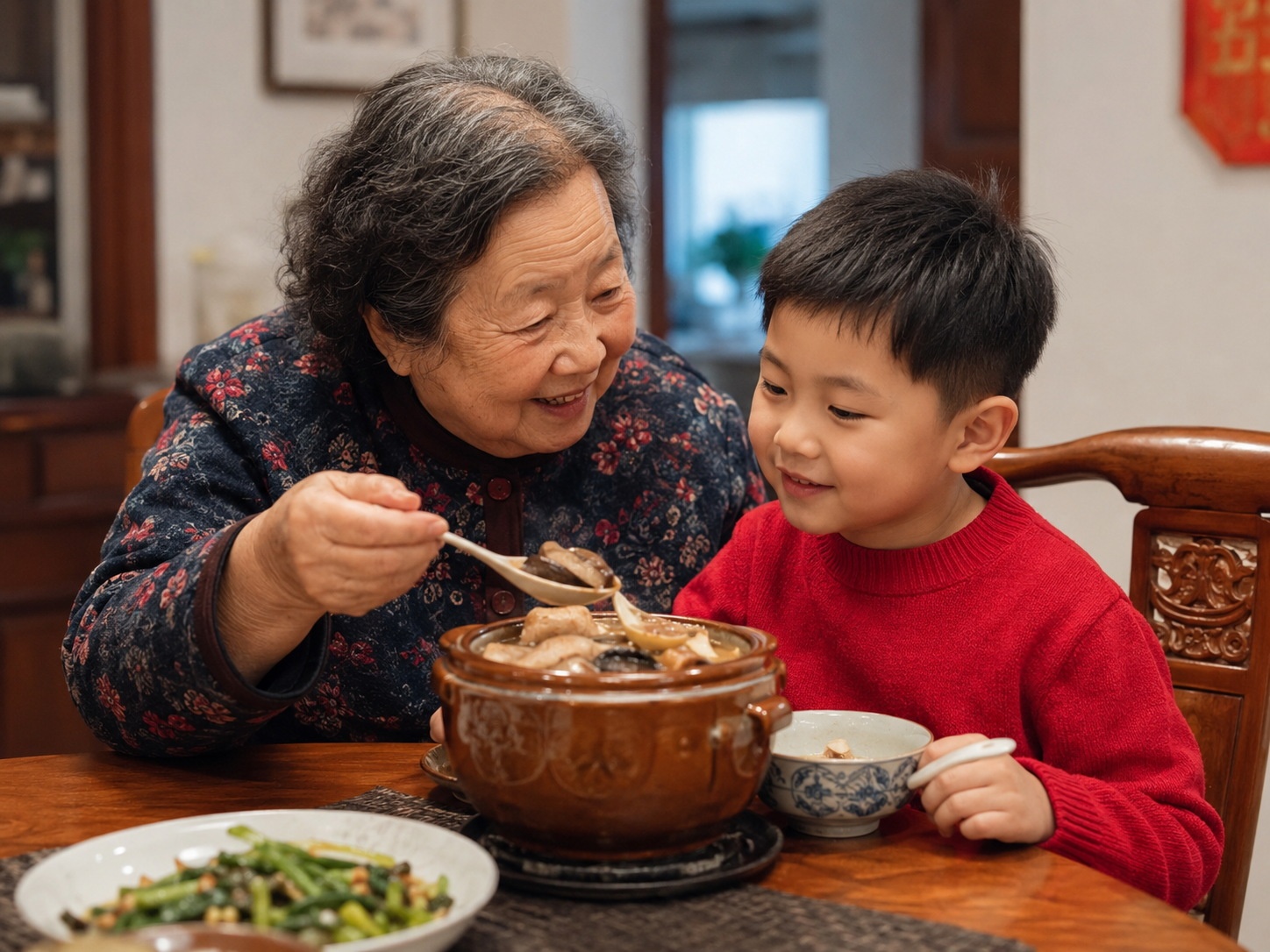 An elderly Chinese woman and her grandson eating from a shared clay pot of Fo Tiao Qiang in a cozy home setting.