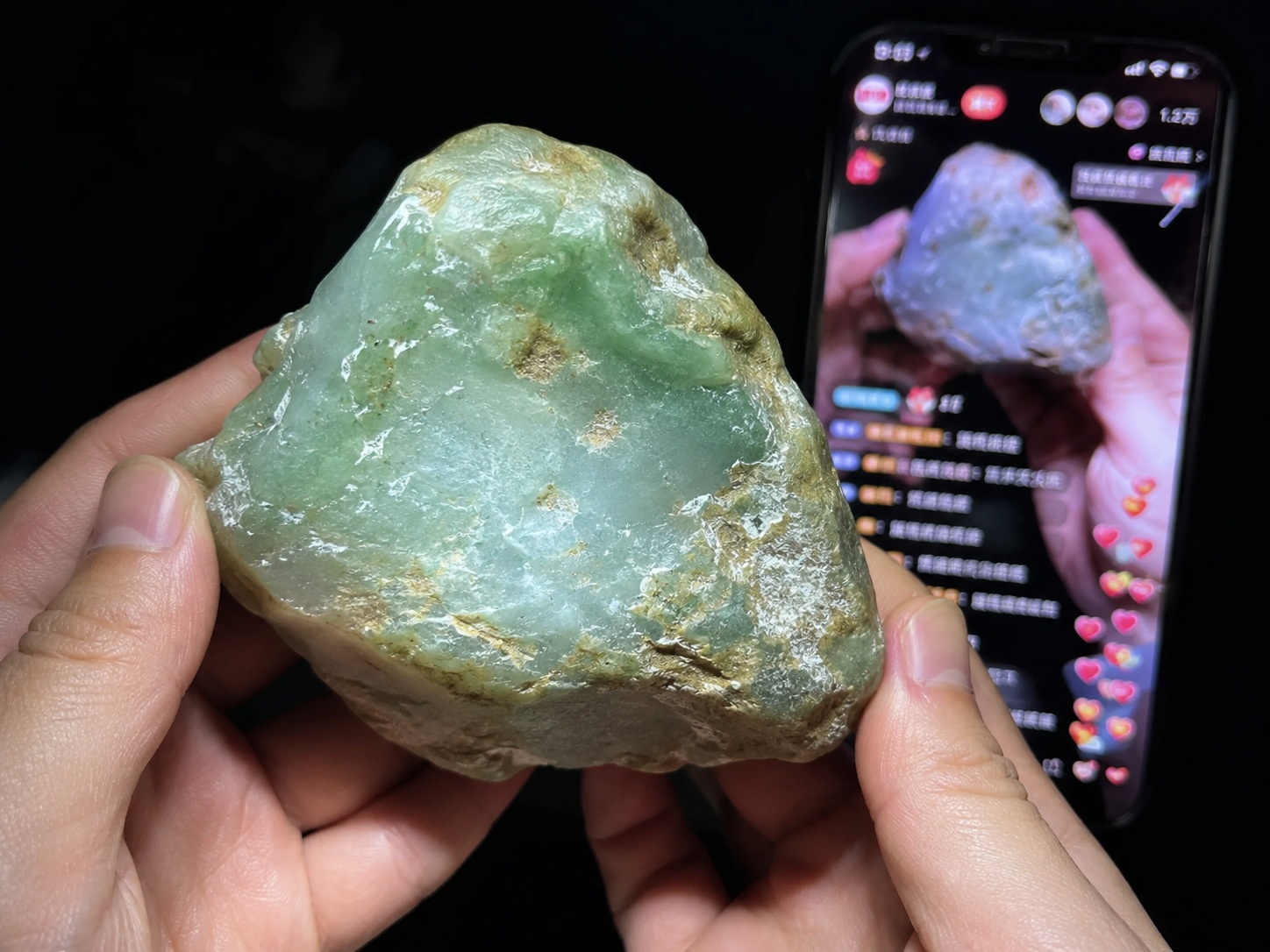 Close-up view of a livestreamer selling jade in a rural Chinese warehouse, highlighting the stone's texture under ring light.