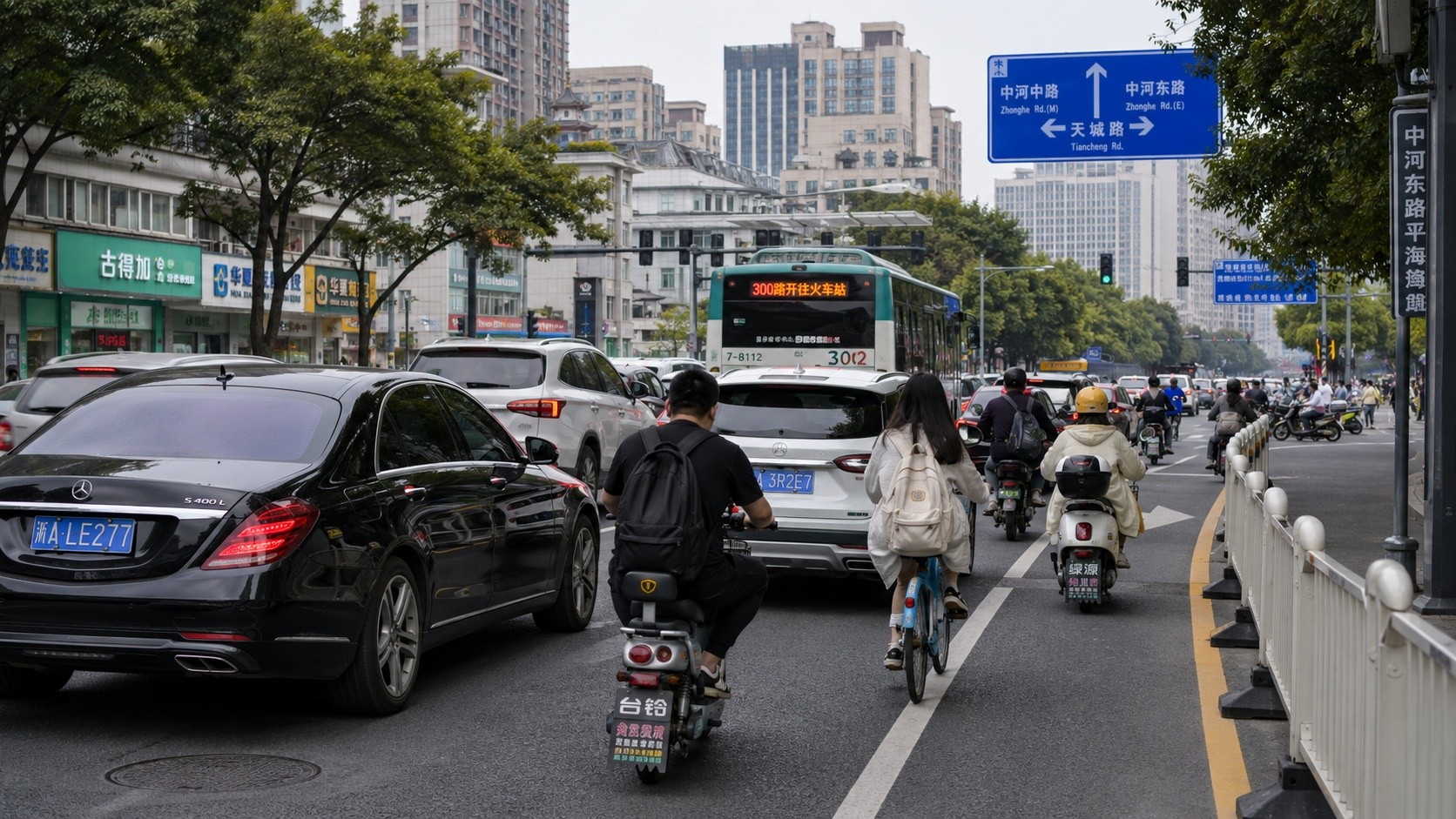 Electric scooters navigating through traffic alongside cars in a Chinese city.