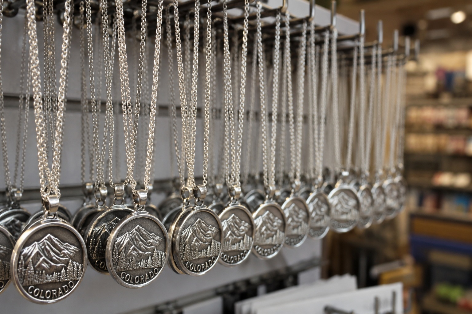 Identical mass-produced silver necklaces displayed in a Chinese ancient town souvenir shop, symbolizing homogenized tourism goods.