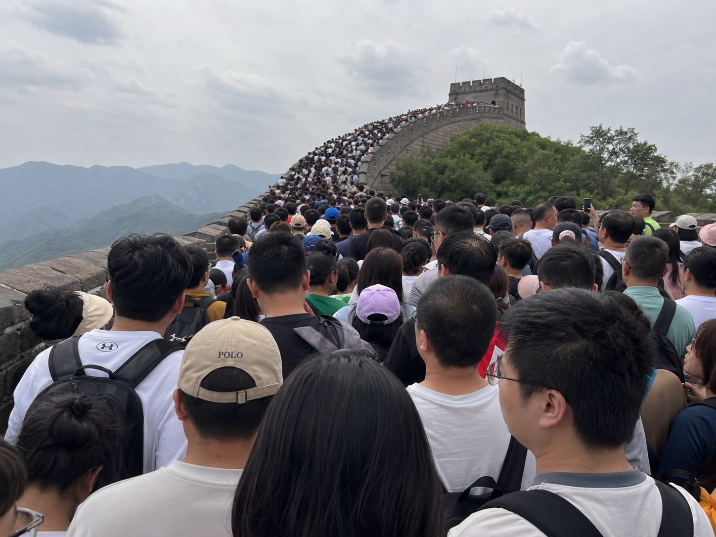 Crowded tourists at a popular Chinese landmark illustrating the challenges of traditional mass tourism.