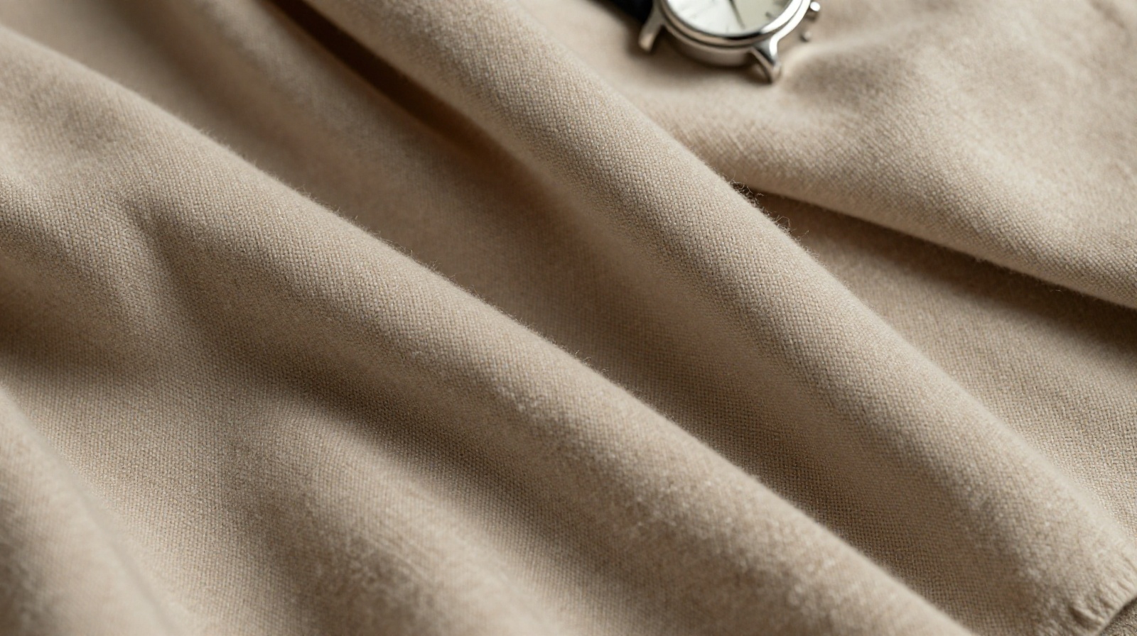 Close-up of unbranded luxury fabrics and an understated watch, symbolizing the shift from flashy logos to quiet luxury in China.