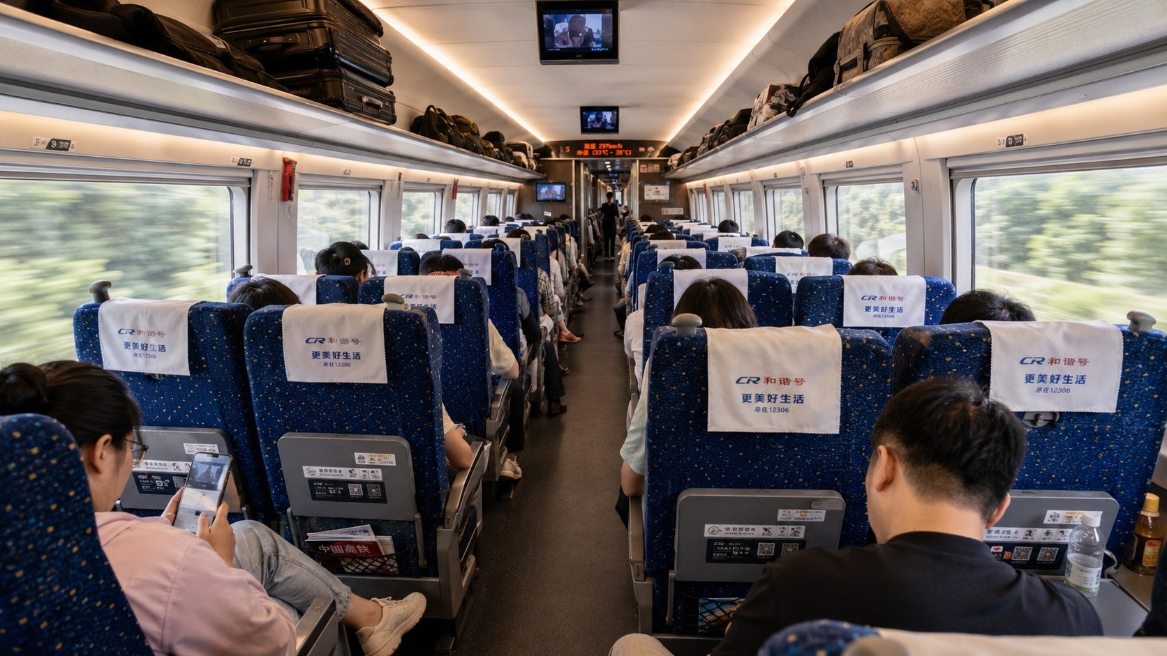 Second class carriage of Chinese bullet train with passengers and blue 2+3 seats