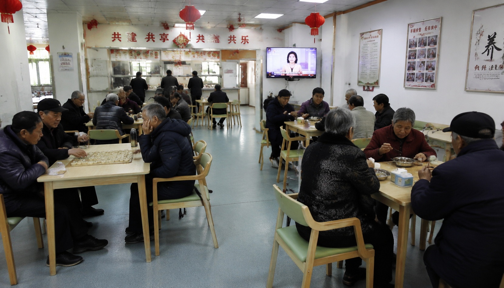 Elderly Chinese people dining and socializing in a community canteen interior