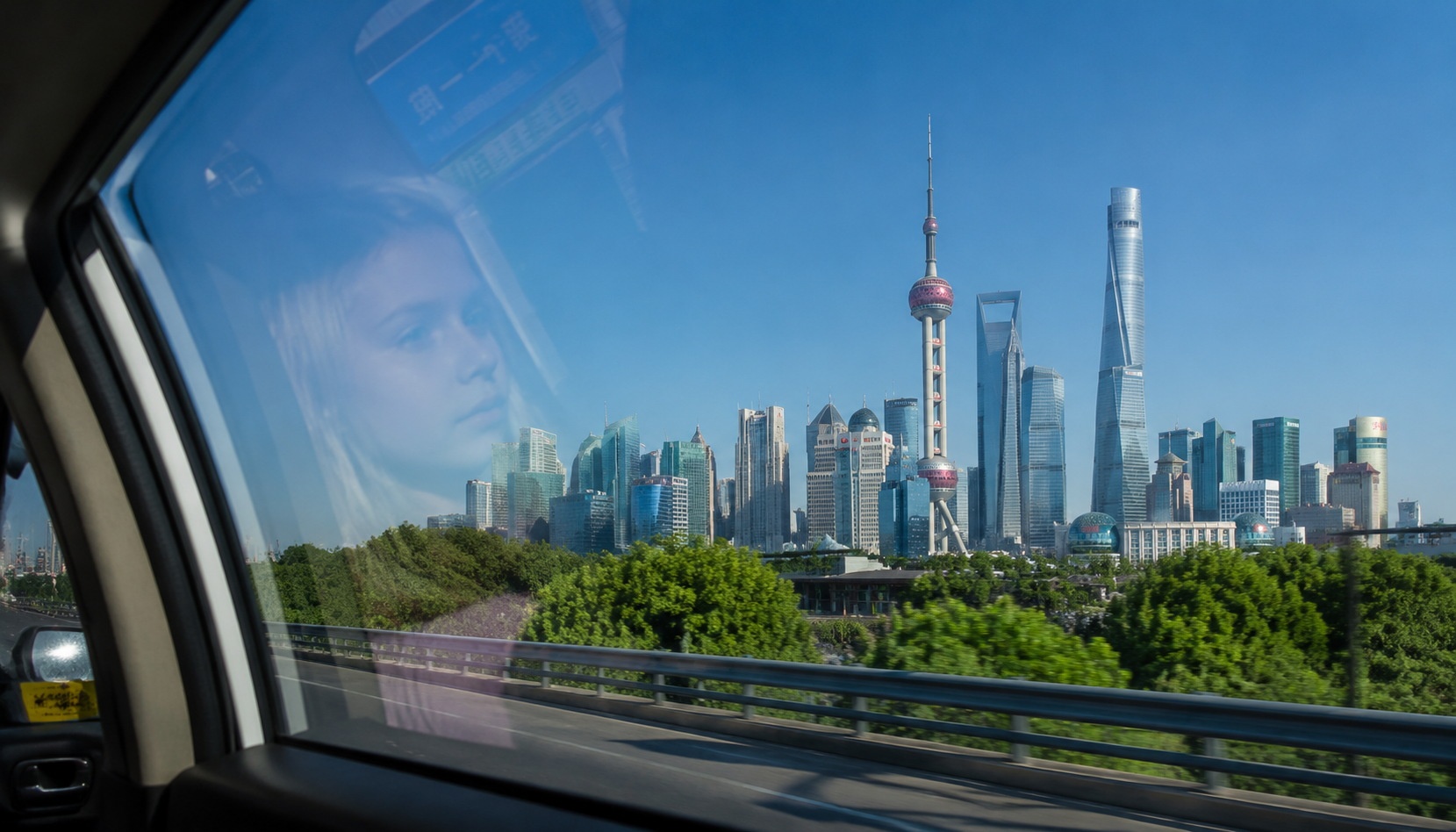 Shanghai skyline with green trees and clean air viewed from a taxi window