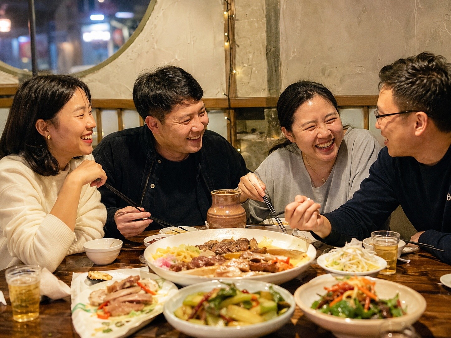 A group of people enjoying a communal meal in Jilin, highlighting the social aspect of Northeast Chinese dining culture.