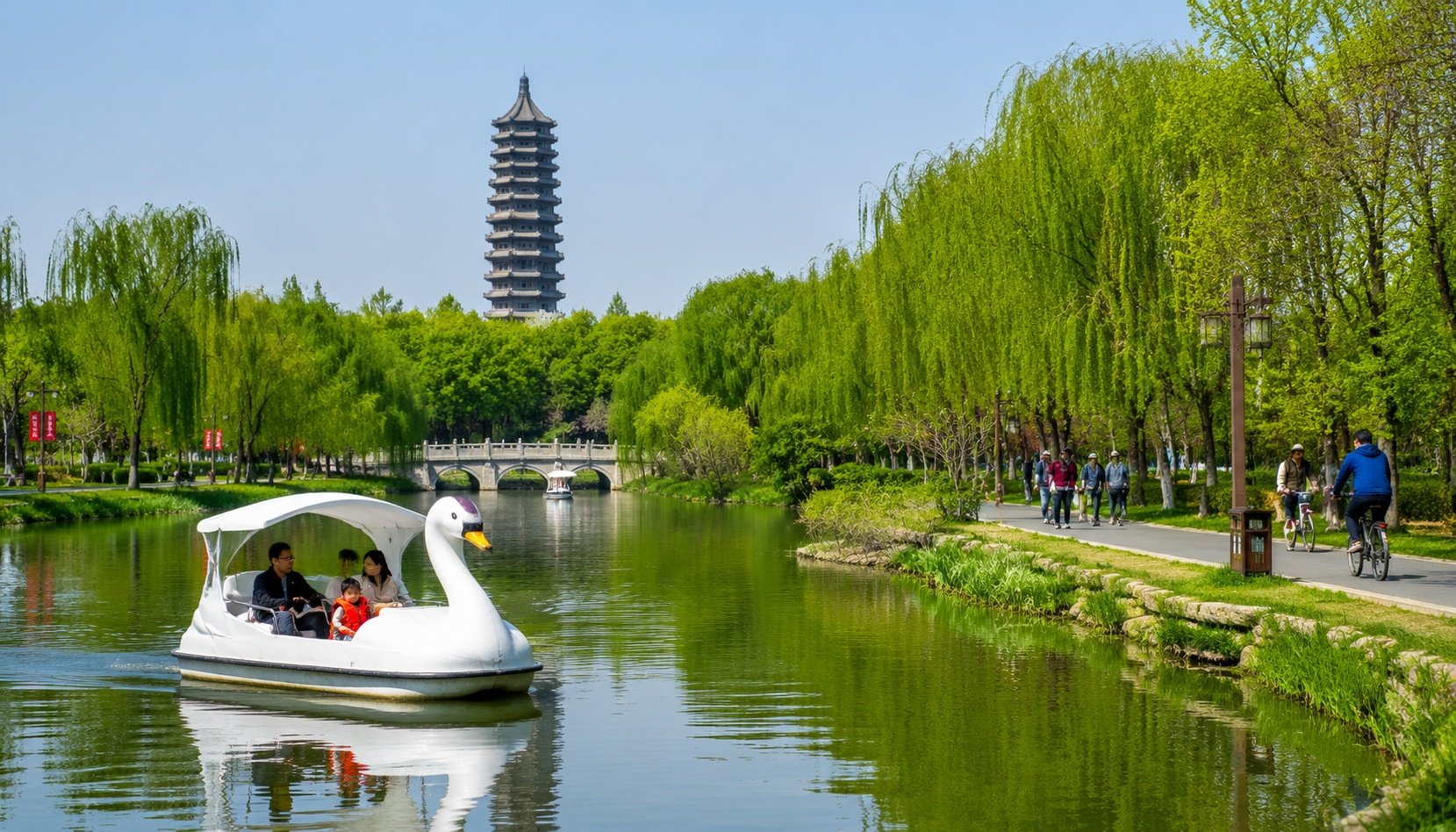 Family riding a pedal boat shaped like a swan on the Grand Canal at Tongzhou Canal Forest Park in Beijing, with the Burning Lamp Pagoda visible in the background.