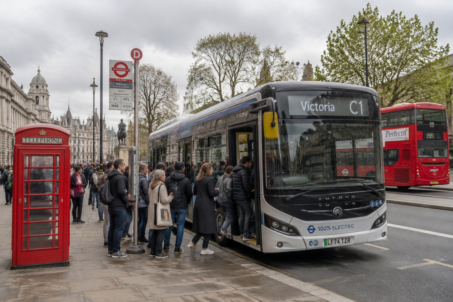 Yutong electric bus on a London street with passengers boarding, alongside a red double-decker