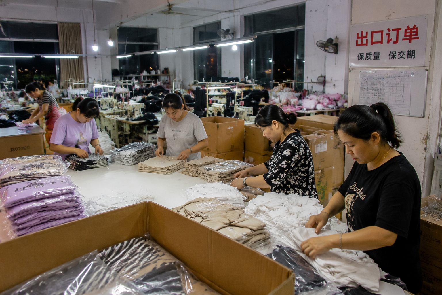 Workers in a Shishi garment factory packing clothes for export to Southeast Asia