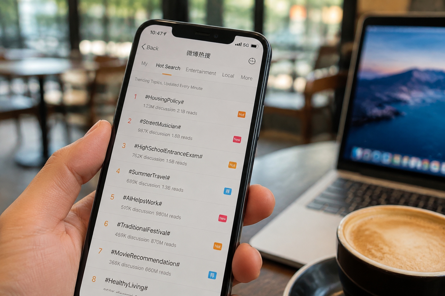 Close-up of a smartphone showing Weibo's Hot Search list with trending hashtags in a café setting, illustrating how Chinese netizens follow real-time public discussions.