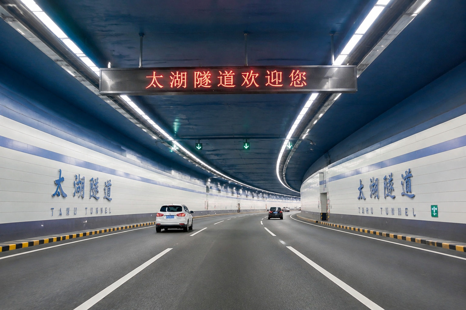Interior view of the wide and brightly lit underwater highway tunnel in China